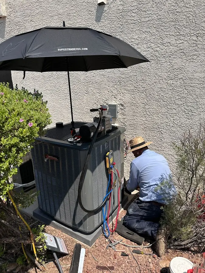 HVAC technician performing outdoor AC maintenance in Weehawken